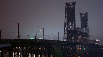 Movie still from “Paranoid Park” (2007), directed by Gus Van Sant – A bridge with lights on the top of it at night time; Extreme Wide shot, High angle