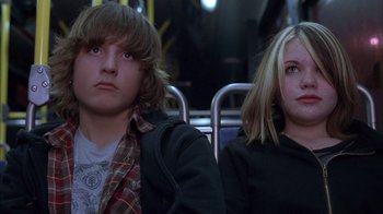 Movie still from “Paranoid Park” (2007), directed by Gus Van Sant – A man and a woman sitting next to each other on a bus; Medium shot, Low angle