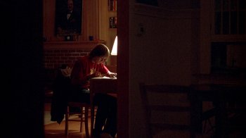 Movie still from “Paranoid Park” (2007), directed by Gus Van Sant – A woman sitting at a table writing on a piece of paper; Wide shot, Low angle