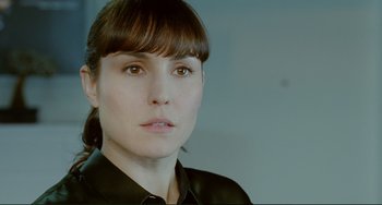 Movie still from “Passion” (2012), directed by Brian De Palma – A person wearing a black shirt; Close Up shot, Over the shoulder angle