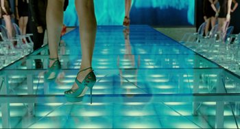 Movie still from “Passion” (2012), directed by Brian De Palma – A pair of women's legs in high heels on a dance floor; Wide shot, Low angle