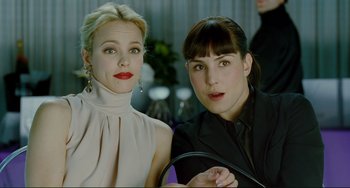 Movie still from “Passion” (2012), directed by Brian De Palma – Two women posing for a picture in front of a mirror; Close Up shot, Over the shoulder angle