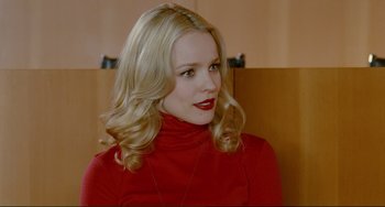 Movie still from “Passion” (2012), directed by Brian De Palma – A woman with blonde hair wearing a red shirt; Close Up shot, Over the shoulder angle