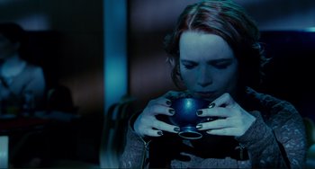 Movie still from “Passion” (2012), directed by Brian De Palma – A woman is holding a blue cup in her hands; Close Up shot, High angle