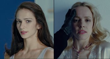 Movie still from “Passion” (2012), directed by Brian De Palma – A woman in a white dress and a woman in a black dress; Close Up shot, Low angle