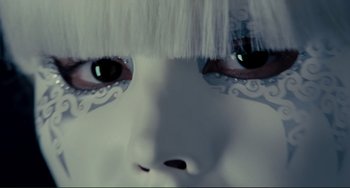 Movie still from “Passion” (2012), directed by Brian De Palma – View of a woman's face with white makeup; Extreme Close Up shot, Overhead angle