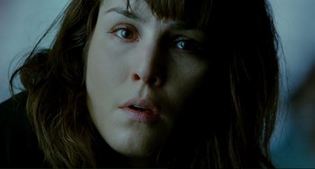 Movie still from “Passion” (2012), directed by Brian De Palma – A woman's face in the dark; Close Up shot, Low angle