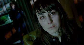 Movie still from “Passion” (2012), directed by Brian De Palma – A person looking at the camera; Close Up shot, High angle