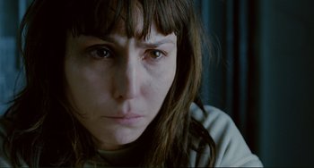 Movie still from “Passion” (2012), directed by Brian De Palma – A person with long brown hair; Close Up shot, High angle