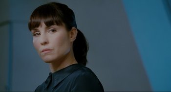 Movie still from “Passion” (2012), directed by Brian De Palma – A person wearing a black shirt; Close Up shot, Low angle