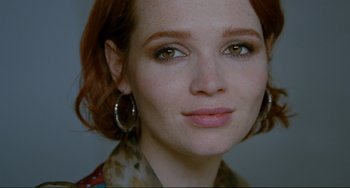 Movie still from “Passion” (2012), directed by Brian De Palma – A woman with red hair and green eyes; Close Up shot, Over the shoulder angle