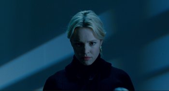 Movie still from “Passion” (2012), directed by Brian De Palma – A woman with blonde hair is looking at the camera; Close Up shot, Low angle