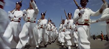 Movie still from “Patton” (1970), directed by Franklin J. Schaffner – A group of men in white uniforms marching down a street; Wide shot, Low angle