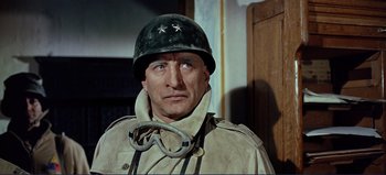 Movie still from “Patton” (1970), directed by Franklin J. Schaffner – A man in a military uniform wearing a helmet; Close Up shot, Low angle