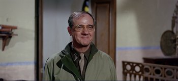 Movie still from “Patton” (1970), directed by Franklin J. Schaffner – An older man wearing glasses and a green jacket; Close Up shot, Over the shoulder angle