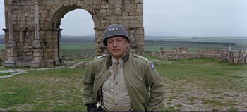 Movie still from “Patton” (1970), directed by Franklin J. Schaffner – A man in a military uniform and a helmet; Medium shot, Low angle