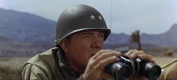 Movie still from “Patton” (1970), directed by Franklin J. Schaffner – A man in a military uniform drinking from a cup; Close Up shot, Low angle