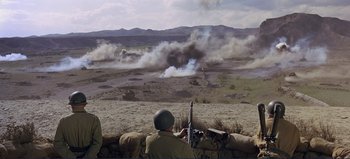 Movie still from “Patton” (1970), directed by Franklin J. Schaffner – A group of men standing on top of a dirt hill; Extreme Wide shot, High angle