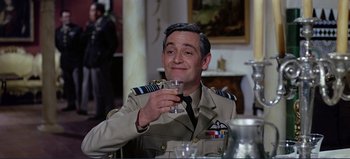 Movie still from “Patton” (1970), directed by Franklin J. Schaffner – A man in uniform holding a glass of wine; Medium shot, High angle