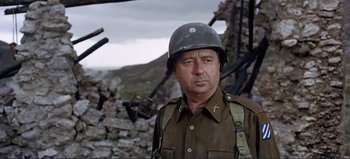 Movie still from “Patton” (1970), directed by Franklin J. Schaffner – A man in a military uniform wearing a helmet; Close Up shot, Over the shoulder angle
