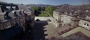 Movie still from “Patton” (1970), directed by Franklin J. Schaffner – An aerial view of an old building with a tank in the middle of it; Extreme Wide shot, High angle
