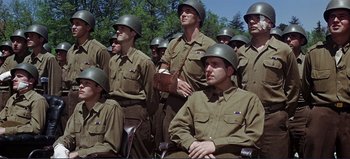 Movie still from “Patton” (1970), directed by Franklin J. Schaffner – A group of men in army fatigues and helmets; Medium shot, Low angle