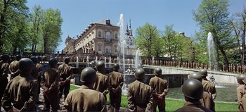 Movie still from “Patton” (1970), directed by Franklin J. Schaffner – A group of men standing next to each other near a fountain; Extreme Wide shot, Low angle