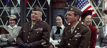 Movie still from “Patton” (1970), directed by Franklin J. Schaffner – A couple of men and a woman in military uniforms; Medium shot, Low angle