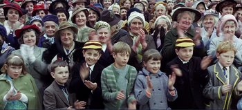 Movie still from “Patton” (1970), directed by Franklin J. Schaffner – A group of people standing next to each other clapping; Medium shot, High angle