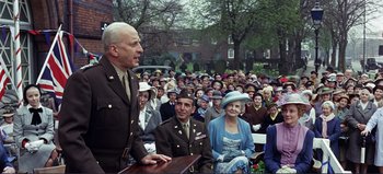 Movie still from “Patton” (1970), directed by Franklin J. Schaffner – An older man in a military uniform speaking to a crowd of people; Medium shot, Low angle