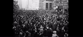 Movie still from “Patton” (1970), directed by Franklin J. Schaffner – A crowd of people standing in the middle of a street; Extreme Wide shot, High angle