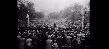Movie still from “Patton” (1970), directed by Franklin J. Schaffner – A large crowd of people gathered in a park to hear a speaker; Extreme Wide shot, High angle