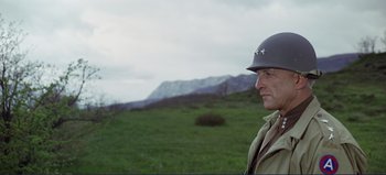 Movie still from “Patton” (1970), directed by Franklin J. Schaffner – A man in a military uniform standing in a field; Close Up shot, Low angle