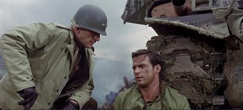 Movie still from “Patton” (1970), directed by Franklin J. Schaffner – Two men in uniforms are sitting next to each other; Medium shot, Over the shoulder angle