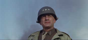 Movie still from “Patton” (1970), directed by Franklin J. Schaffner – A man in a military uniform wearing a helmet; Close Up shot, Low angle