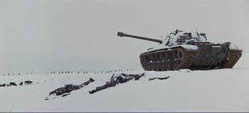 Movie still from “Patton” (1970), directed by Franklin J. Schaffner – A tank is shown in the snow near a hill; Extreme Wide shot, High angle