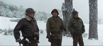 Movie still from “Patton” (1970), directed by Franklin J. Schaffner – A group of men standing next to each other in the snow; Medium shot, Low angle
