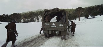 Movie still from “Patton” (1970), directed by Franklin J. Schaffner – A group of men standing in the back of an army vehicle; Wide shot, High angle