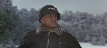 Movie still from “Patton” (1970), directed by Franklin J. Schaffner – A man in a military uniform wearing a helmet; Close Up shot, Low angle
