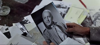 Movie still from “Patton” (1970), directed by Franklin J. Schaffner – An old photo of a man in a priest's outfit; Close Up shot, High angle