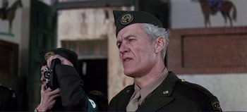 Movie still from “Patton” (1970), directed by Franklin J. Schaffner – An older man in a military uniform looking at the camera; Close Up shot, Low angle