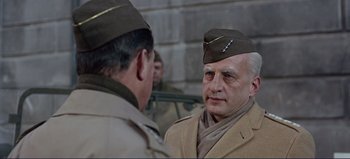 Movie still from “Patton” (1970), directed by Franklin J. Schaffner – A man in a military uniform talking to another man in a uniform; Close Up shot, Low angle