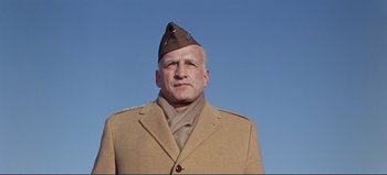 Movie still from “Patton” (1970), directed by Franklin J. Schaffner – A man in a military uniform is looking at the camera; Close Up shot, Low angle