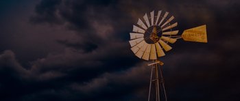 Movie still from “Paul” (2011), directed by Greg Mottola – An old fashioned windmill in front of a cloudy sky; Extreme Wide shot, Low angle