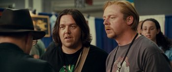 Movie still from “Paul” (2011), directed by Greg Mottola – A couple of men standing next to each other; Close Up shot, Over the shoulder angle