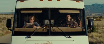 Movie still from “Paul” (2011), directed by Greg Mottola – Two men sitting in the window of a bus; Medium shot, Low angle