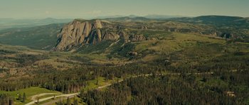 Movie still from “Paul” (2011), directed by Greg Mottola – An aerial view of a mountain range with a road going through it; Extreme Wide shot, High angle