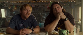 Movie still from “Paul” (2011), directed by Greg Mottola – Two people sitting at a table with food; Close Up shot, Low angle