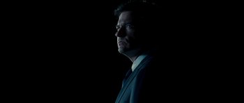 Movie still from “Paul” (2011), directed by Greg Mottola – A person wearing a suit and tie; Close Up shot, Low angle