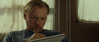 Movie still from “Paul” (2011), directed by Greg Mottola – A person writing on a piece of paper; Close Up shot, Over the shoulder angle